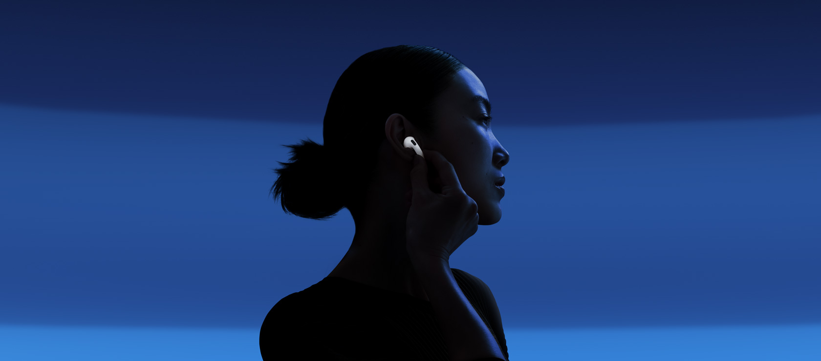 A person enabling Active Noise Cancellation by touching the stem.