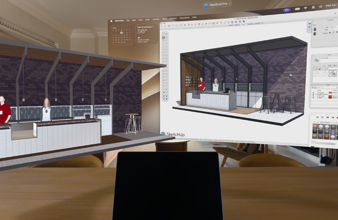 Apple Vision Pro view, MacBook Pro sits on a surface with 3D models projected behind it, models show a cafe service counter with two people standing behind it